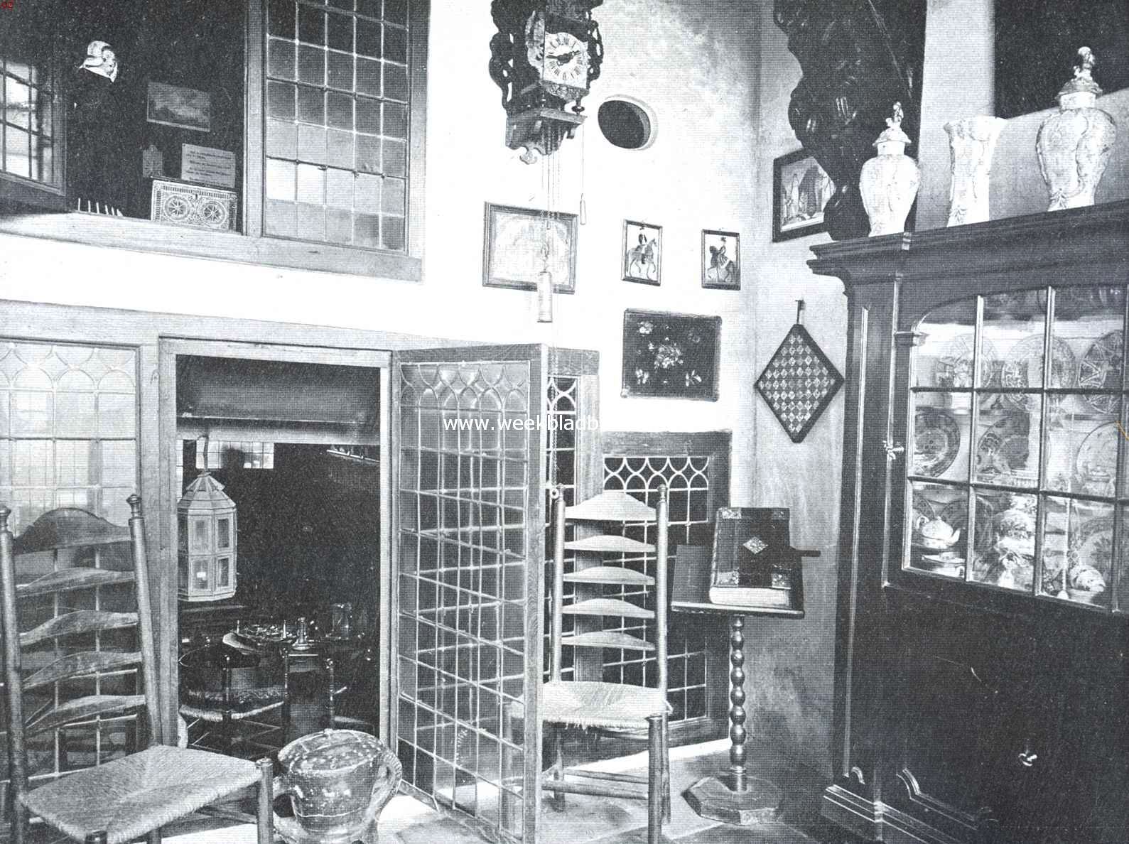 Edam. Achter-benedenvertrek in Edam's Museum. Het openslaande raampje beneden geeft een kijkje in de kelderkamer, het raampje daarboven in het tweede opkamertje. Het ronde, veel op een patrijspoort gelijkende raampje rechts van de Friesche klok geeft licht aan de daarachter gelegen bedstede. Links boven de porceleinkast de kunstig gesneden balkdrager