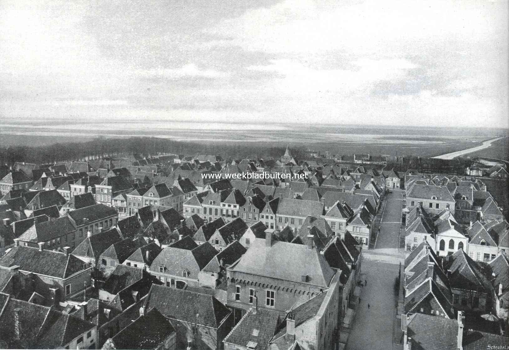 Elburg. Van den kerktoren af gezien. Op den voorgrond in het midden het stadhuis met den ouden zij- en den schrikkelijk verknoeiden voorgevel, op den achtergrond de Zuiderzee