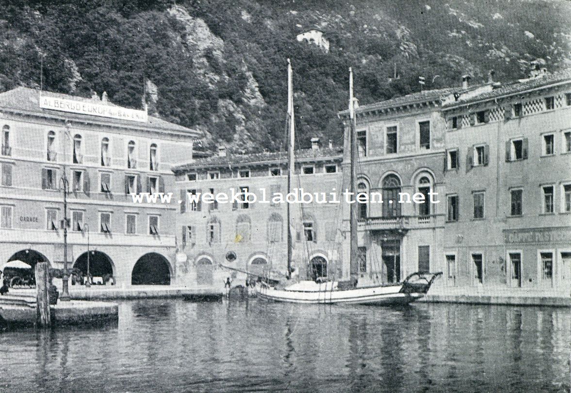 RIVA SUL GARDA. DE HAVEN VAN RIVA. LINKS HOTEL EUROPA. OP DEN ACHTERGROND DE MET BOOMEN BEGROEIDE BERGEN